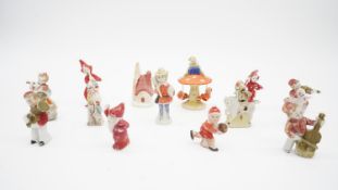 Fifteen vintage hand painted bisque porcelain cake decorations. Including a penguin, pixie, pixie