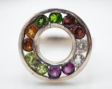 A white metal bespoke made multi gemstone halo ring. Set with coloured garnets, white sapphires