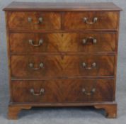 A Georgian flame mahogany chest of drawers with brass swan neck handles on shaped bracket feet. H.