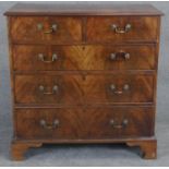 A Georgian flame mahogany chest of drawers with brass swan neck handles on shaped bracket feet. H.