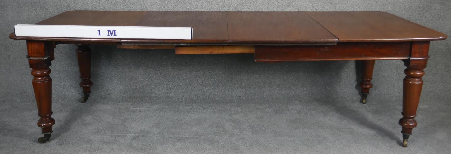 A mid Victorian mahogany extending dining table, the moulded rounded rectangular top with two - Image 4 of 6