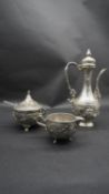 A silver plate relief swag and floral design three piece Islamic coffee set, with coffee jug,