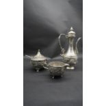 A silver plate relief swag and floral design three piece Islamic coffee set, with coffee jug,