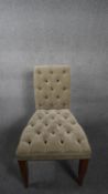 A Chelsea Harbour Design Centre side chair in deep buttoned and piped upholstery raised on slender