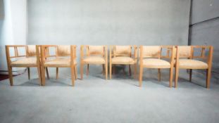 A set of six De Le Espada light oak tub dining chairs in floral upholstery. H.70 W.54 D.47