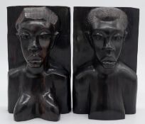 A pair of carved hardwood African tribal bust book ends. H.25cm