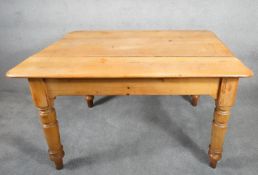 A 19th century pine kitchen table with frieze drawer fitted for cutlery raised on turned tapering