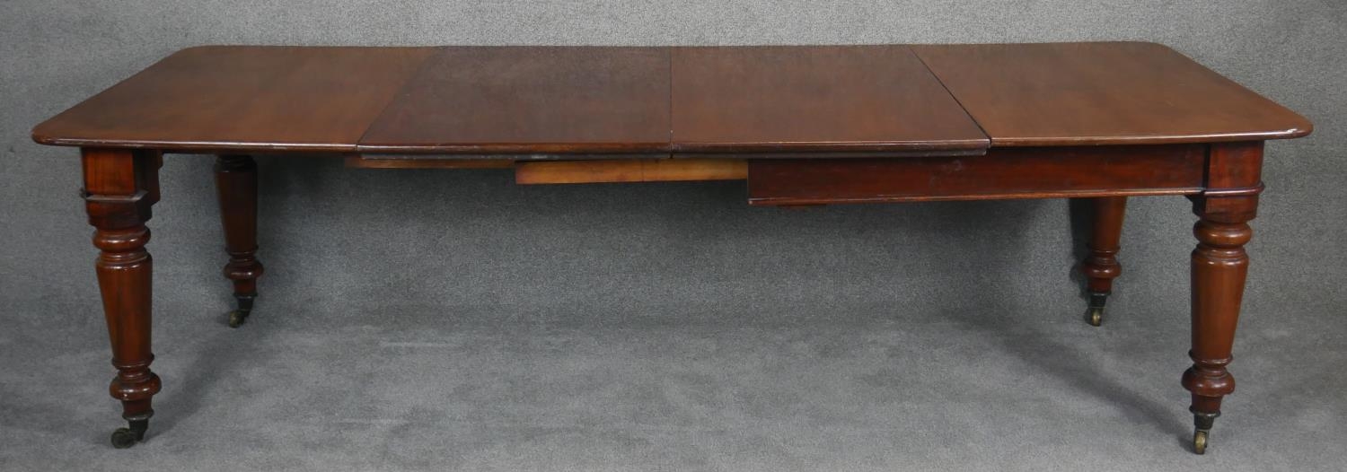 A mid Victorian mahogany extending dining table, the moulded rounded rectangular top with two - Image 3 of 6