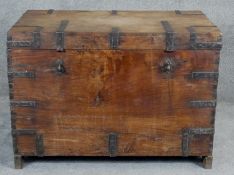 A 19th century iron bound camphor travelling trunk with twin metal carrying handles on shaped