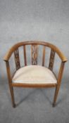 An Edwardian mahogany and satinwood inlaid armchair on square tapering supports terminating in spade