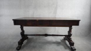 A mid 19th century rosewood library table on carved stretchered platform base. In need of