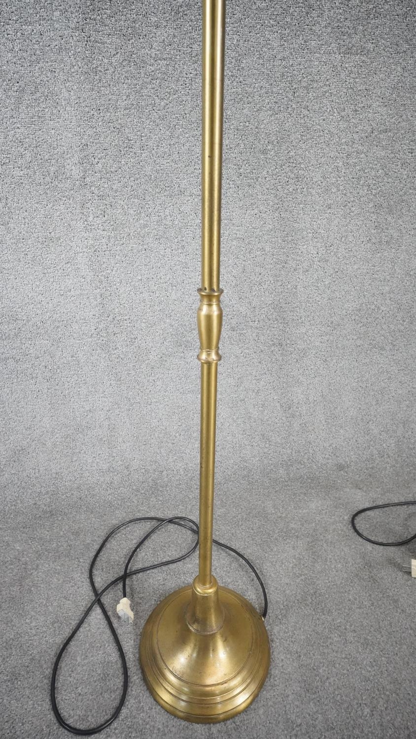 A pair of contemporary brushed brass swing arm height adjustable floor lamps with circular bases. - Image 3 of 5