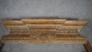 A George II mid 18th century pine breakfront chimney piece architrave carved with acanthus, egg and