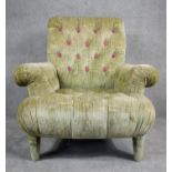 A contemporary Victorian style roll arm easy chair in deep, purple floral buttoned upholstery on