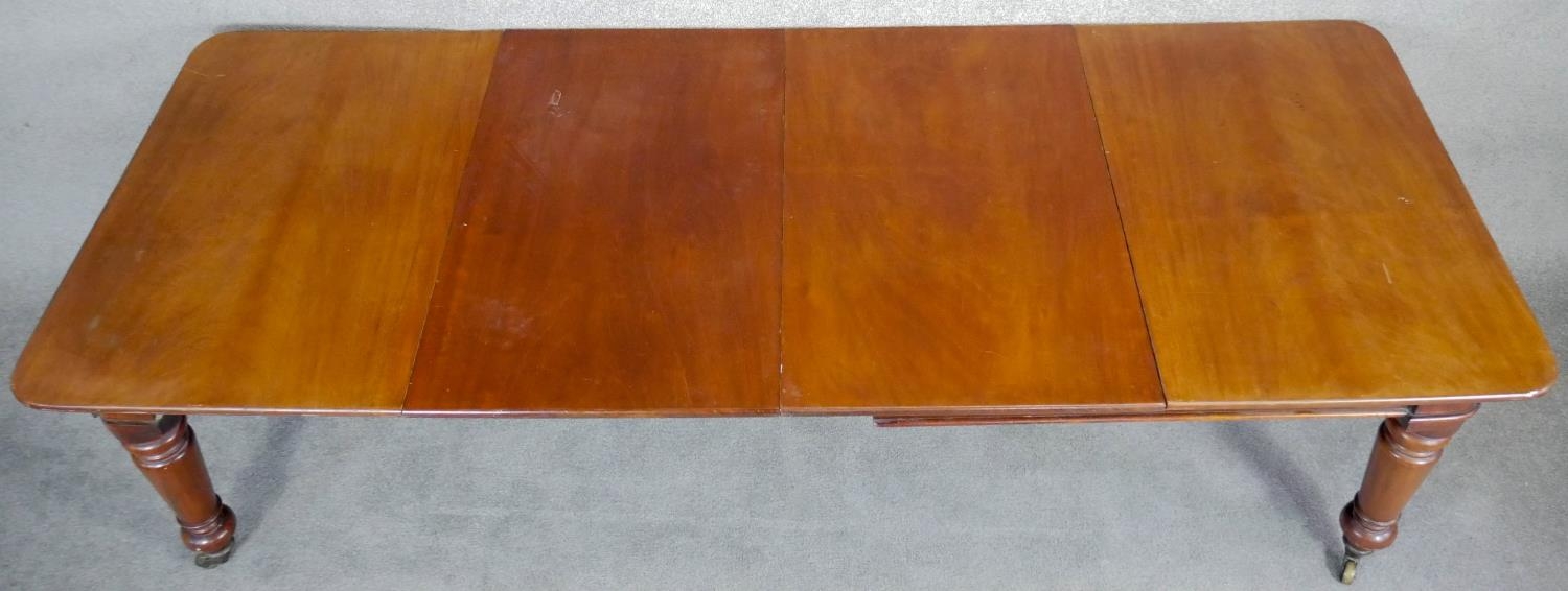 A mid Victorian mahogany extending dining table, the moulded rounded rectangular top with two - Image 6 of 6