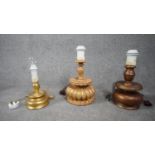 Three carved wooden and gilded table lamps. Including one with a stylised floral design. H.38