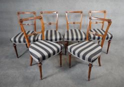 A set of six Victorian walnut framed dining chairs with flowerhead carved back splats above