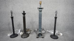 A set of contemporary column table lights, one bronze effect lamp with circular design base. H.62