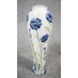 A William Moorcroft Macintyre Florian vase, tube lined with Blue Poppy pattern, of slender