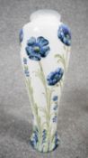 A William Moorcroft Macintyre Florian vase, tube lined with Blue Poppy pattern, of slender