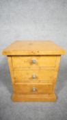 An Art Deco style burr walnut pedestal chest of three drawers on plinth base. H.48