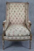 A 19th century Louis XVI style carved giltwood armchair in floral tapestry upholstery on spiral