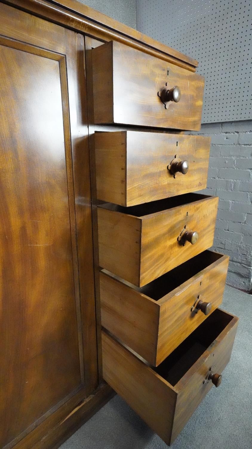 An mid 19th century mahogany linen cupboard with central panel doors flanked by two banks of four - Image 12 of 14