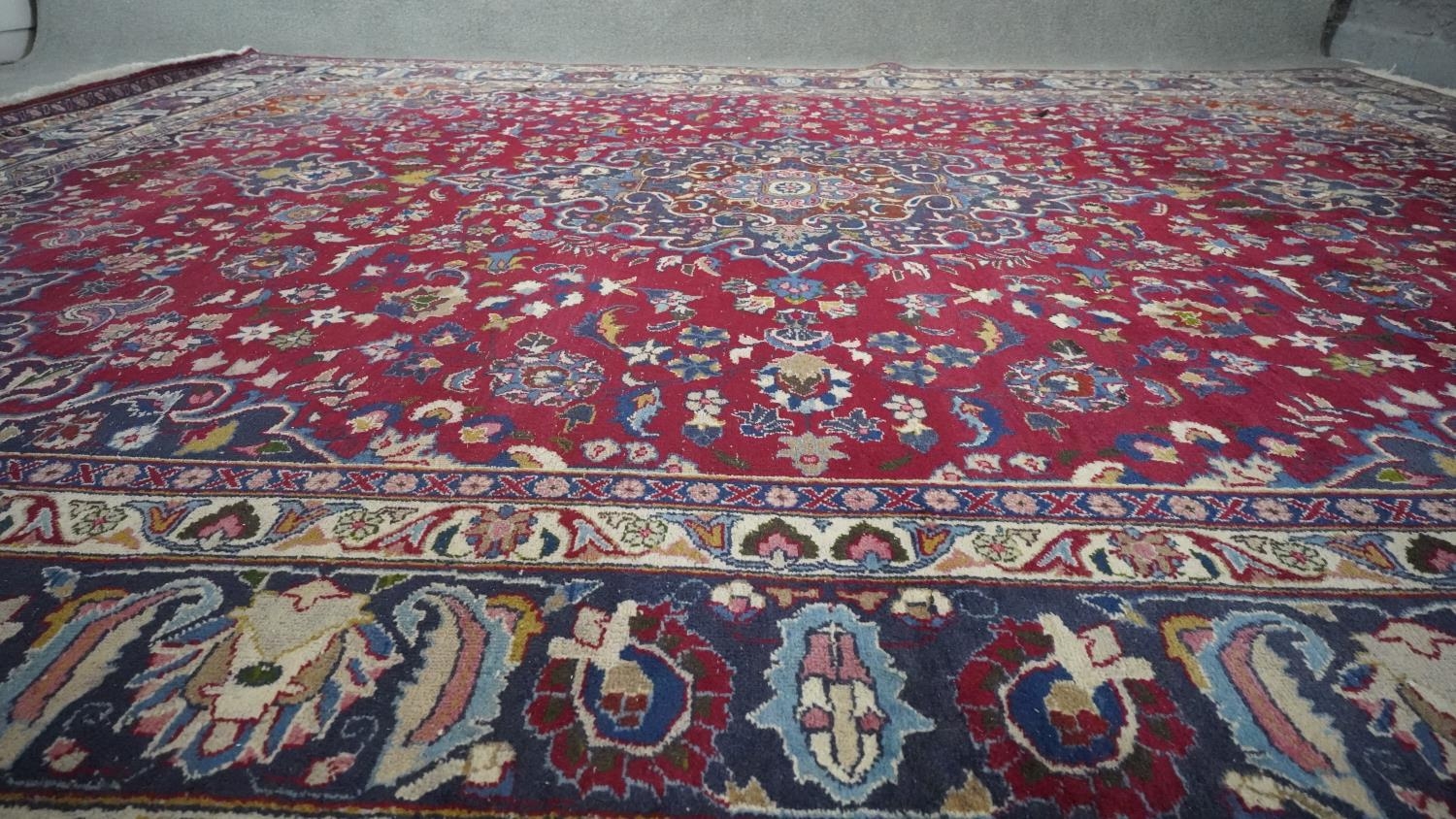 A Persian Mershed carpet with central medallion within a blue foliate border. H.330 W.242