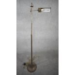 A vintage solid brass height adjustable swing arm floor lamp with triangular shade and circular