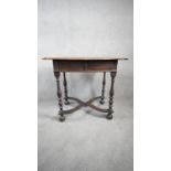 A William and Mary oak side table fitted with frieze drawer on baluster turned supports united by