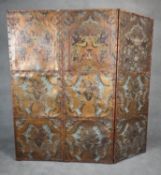A vintage embossed leather three panel screen or room divider with all over polychrome bird and
