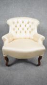 A Victorian bedroom chair in deep buttoned and piped upholstery on mahogany cabriole supports. H.