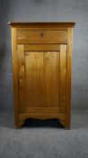 A late 19th century French birch pier cabinet with frieze drawer above panel door on block supports.