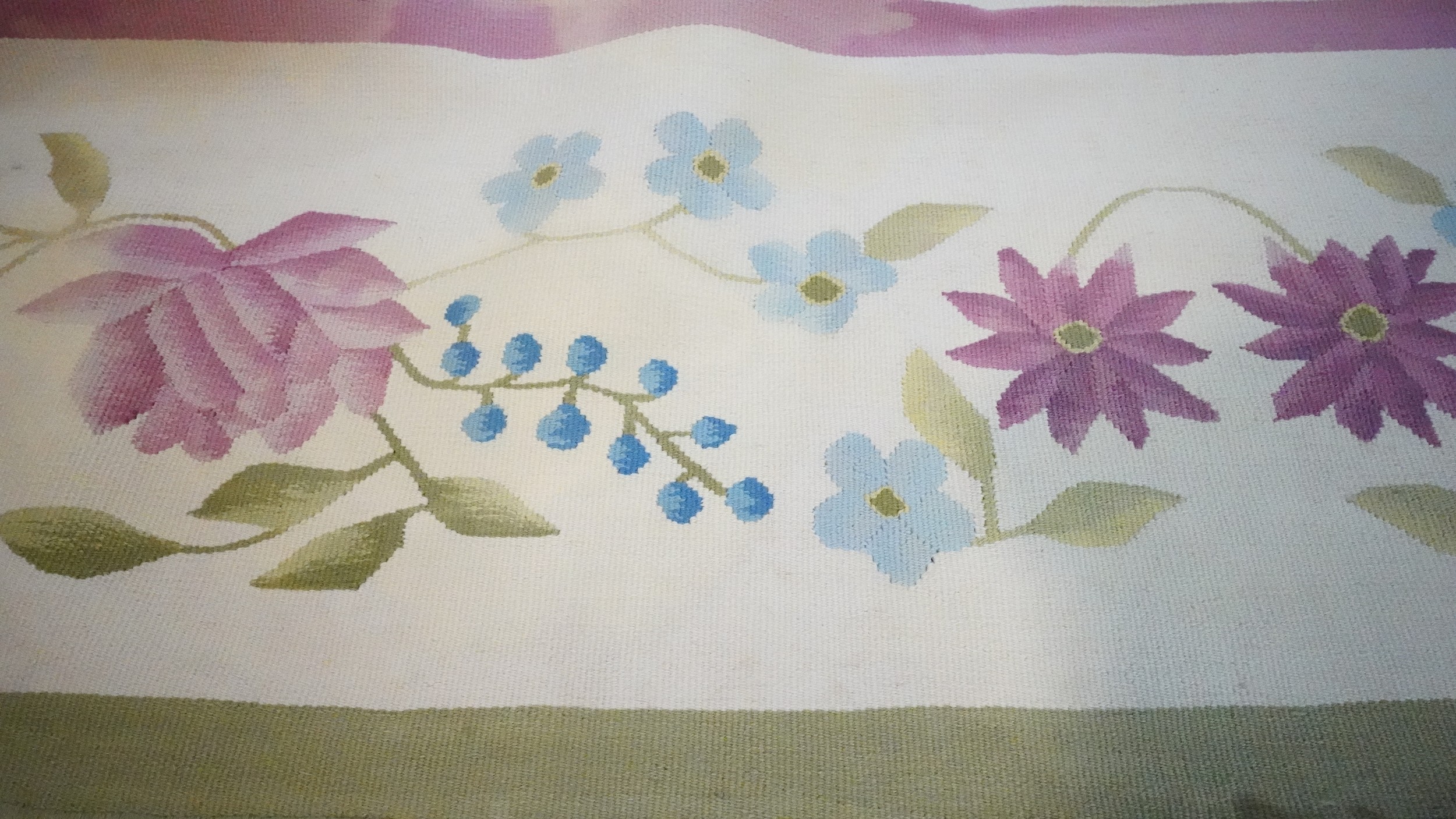 A needlepoint carpet on a cream ground within a floral border. H.258 W.256 - Image 2 of 7