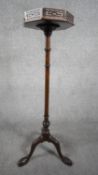 A late 19th century mahogany urn stand with pierced galleried top on carved pedestal with tripod