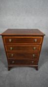 A Georgian style mahogany and satinwood crossbanded small chest of four drawers on swept bracket