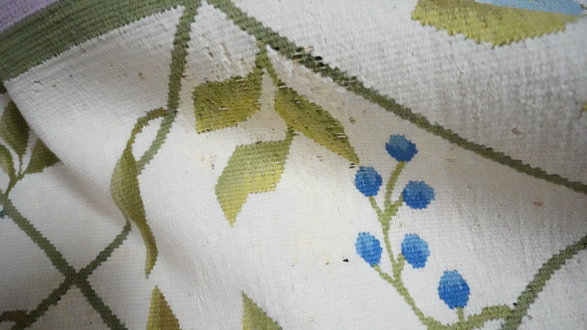 A needlepoint carpet on a cream ground within a floral border. H.258 W.256 - Image 4 of 7