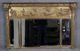 A Regency gilt overmantel mirror with ball decorated architectural cornice above frieze with