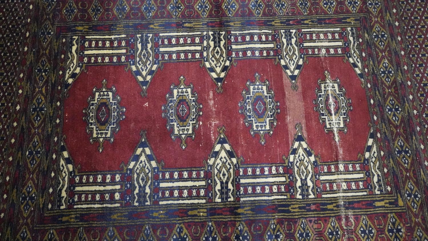 A signed Pakistan Bokhara rug with red ground within a central pendant motif. H.185 W.135 - Image 3 of 5