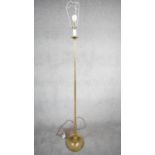 A vintage solid brass candle design height adjustable standard lamp with ridged circular base.