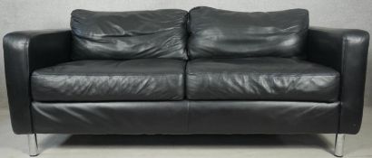 A black leather two seater sofa on tubular chrome supports. H.76 L.185 D.92cm