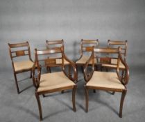 A set of six Regency mahogany style dining chairs with brass inlaid decoration and drop in seats