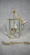 A Victorian style brass and glass porch lantern. The lamp of a hexagonal form with six bevelled