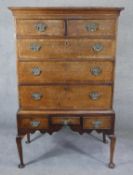 A Georgian oak and mahogany crossbanded chest on stand with shaped apron raised on cabriole pad foot