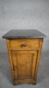 A late 19th century French oak pedestal cabinet with marble top above frieze drawer and panel door