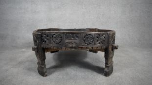 An Indian hardwood low table with carved frieze and cross stretchered supports. H.36 W.74 D.72