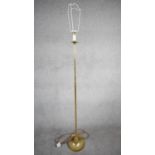 A vintage solid brass candle design height adjustable standard lamp with ridged weighted circular