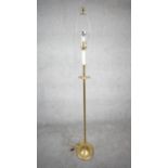 A vintage solid brass candle design height adjustable standard lamp with ridged circular base. H.160