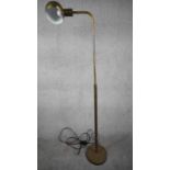 A Mid Century apothecary style solid brass height adjustable floor lamp. Domed shade has painted