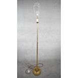 A vintage solid brass candle design height adjustable standard lamp with ridged circular base. H.167